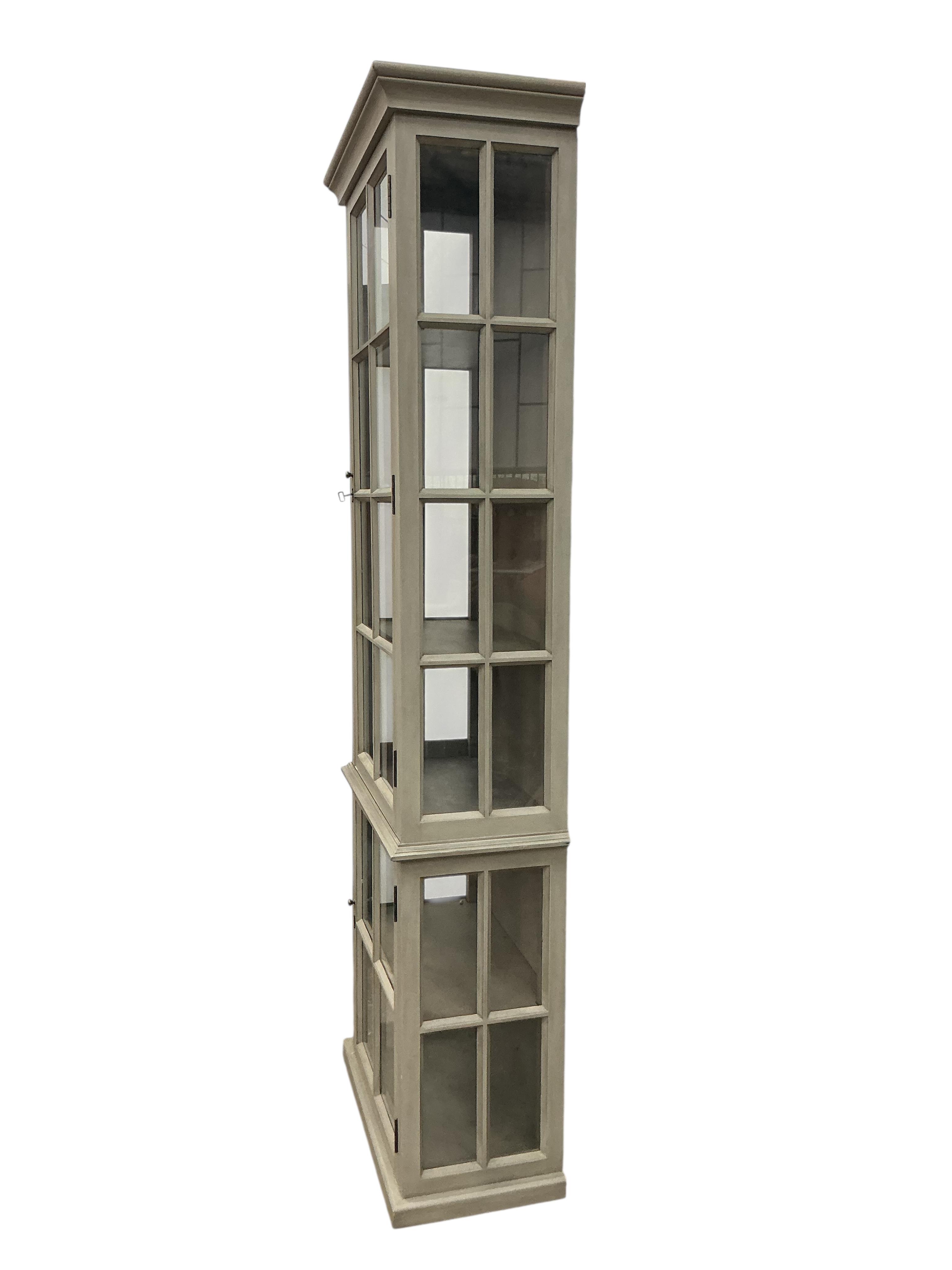 A Contemporary painted narrow cabinet, in two parts, width 73cm, depth 39cm, height 130cm